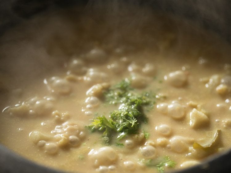 closeup of cauliflower korma cooking in saucepan