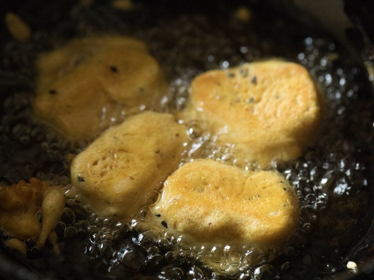 frying cheese pakoras in hot oil. 