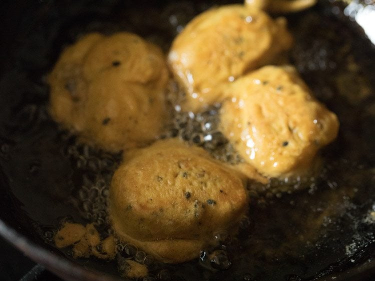 frying cheese pakoras in hot oil. 