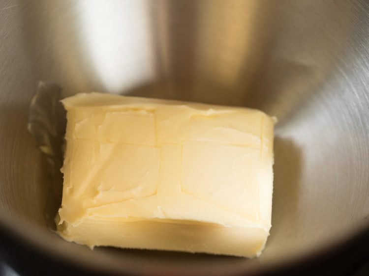 block of butter in a stand mixer bowl.