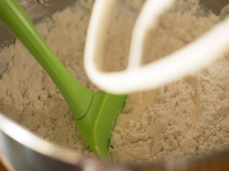 green spatula in the butter cake batter mixture.