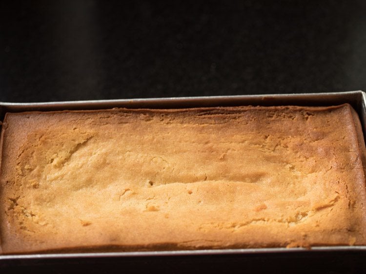 baked and golden butter cake in loaf pan.