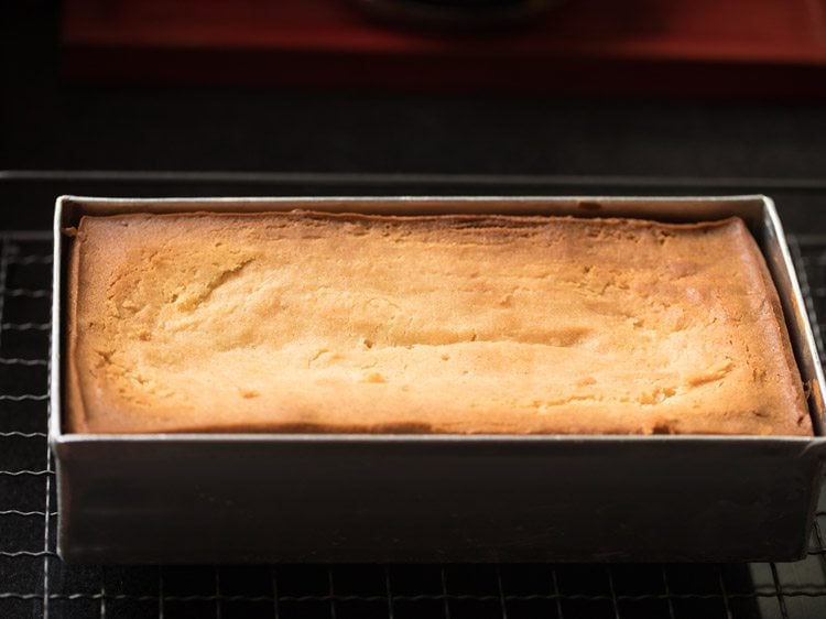 loaf pan on wired tray for butter cake to cool.