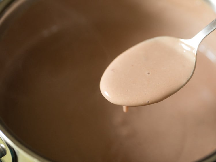 eggless chocolate pudding consistency in a spoon