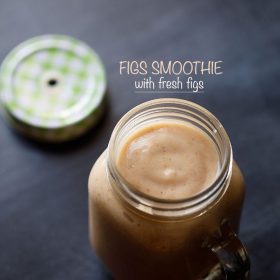 fig smoothie in a drinking glass jar with the lid on the side.