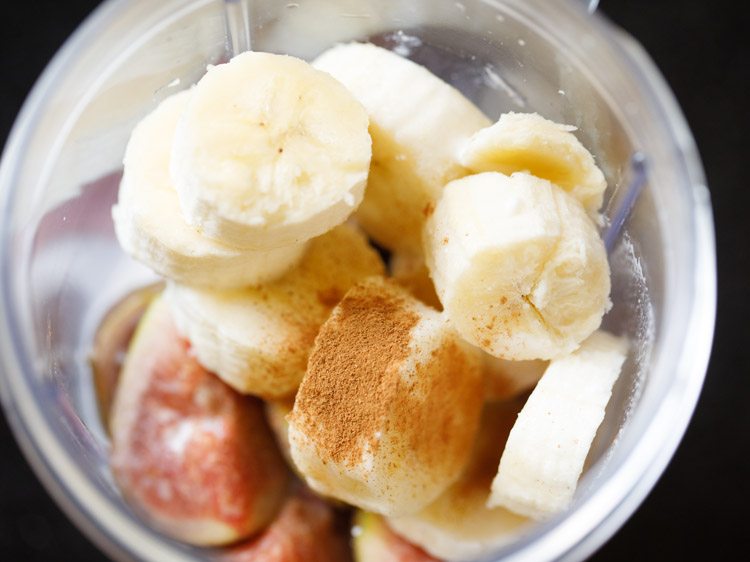 adding thin or medium consistency coconut milk and cinnamon powder to the blender jar 