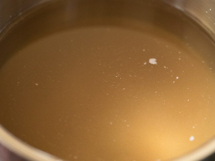 pan with sugar-water mixture kept on stovetop for karah prasad. 