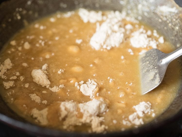 stirring whole wheat flour into the melted ghee for karah prasad. 