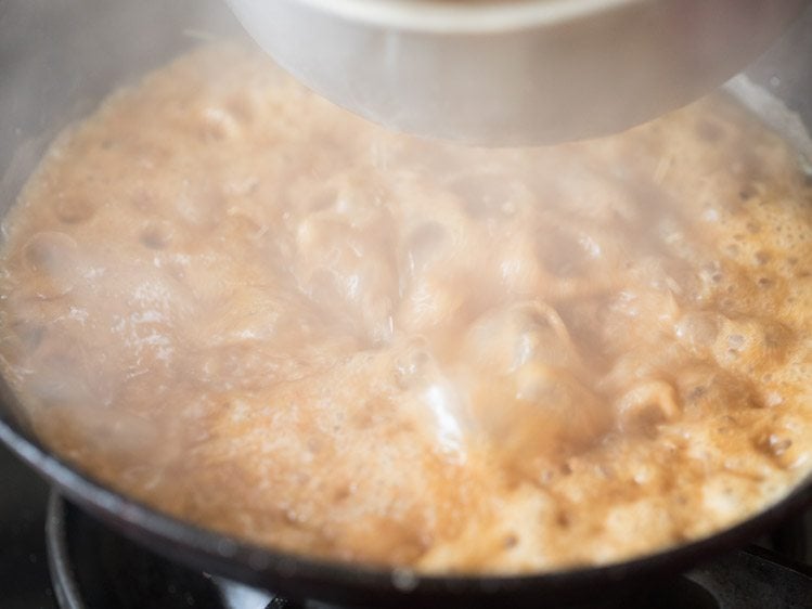 adding one part of bubbling hot sugar solution to fried whole wheat flour. 