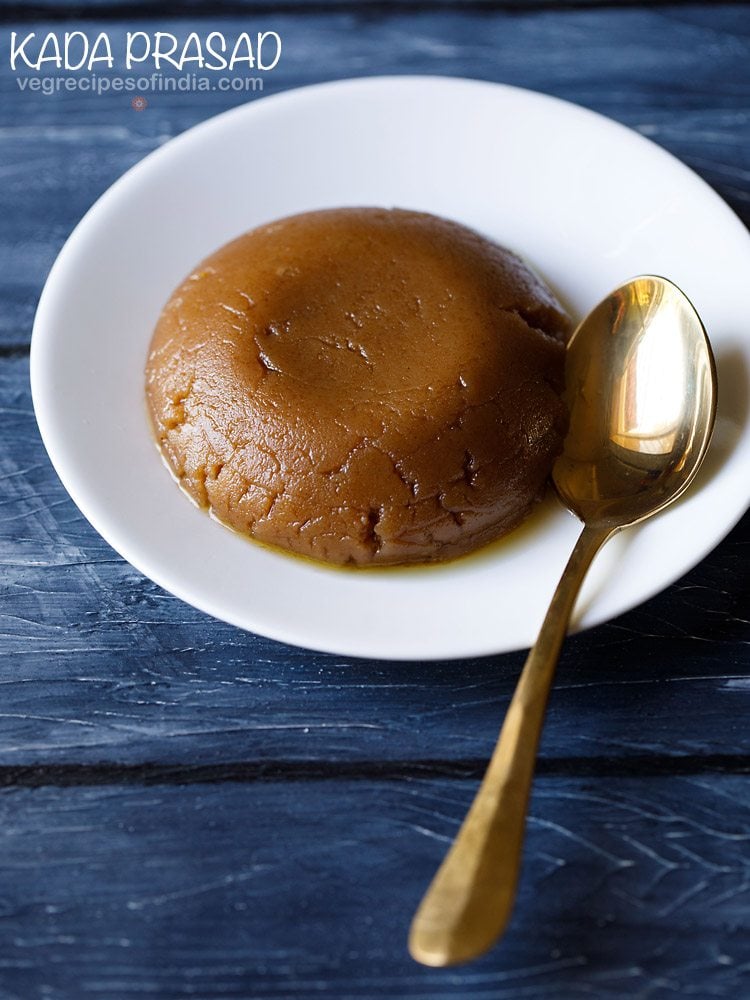 kada prasad served on a white plate with a spoon kept on the right side and text layovers. 