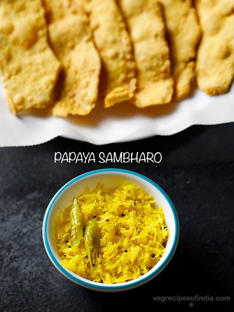 papaya chutney served in a blue rimmed bowl with a plate of fafda kept on the upper side and text layovers.