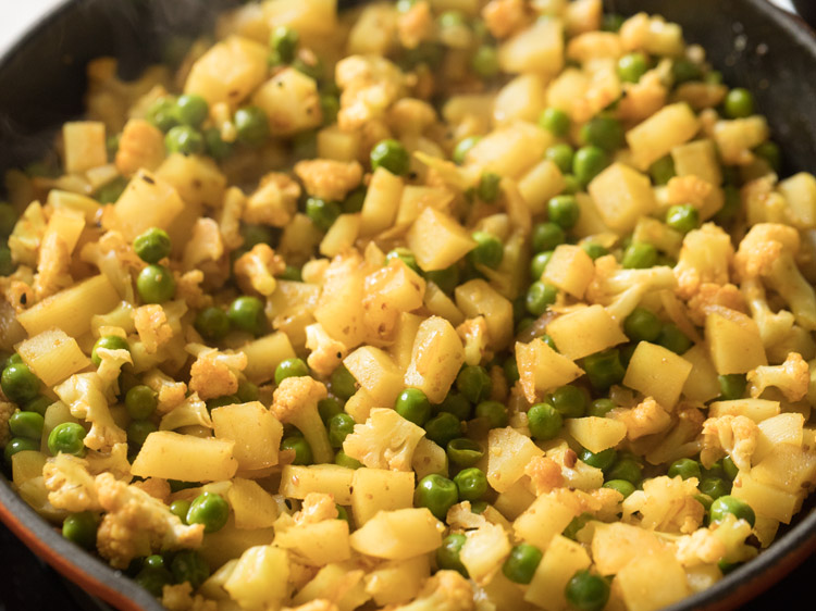 simmering vegetables in pan. 