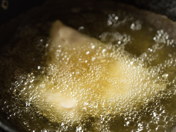 frying shingara in hot oil. 