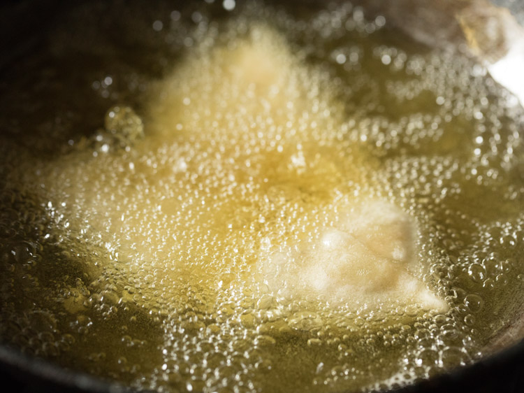 frying shingara in hot oil. 