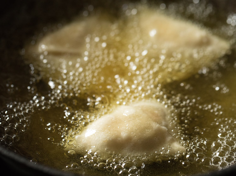 frying shingara in hot oil. 