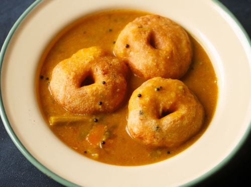 Medu Vada served in a bowl with sambar