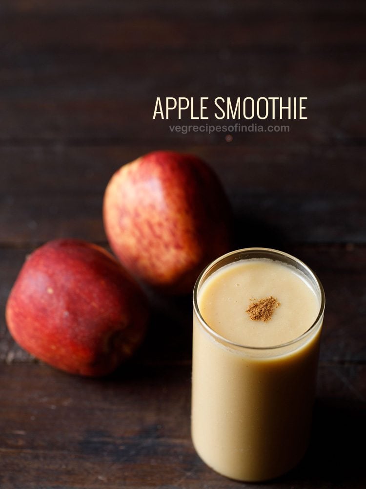 apple smoothie served in a glass garnished with cinnamon powder with two apples kept on the side with text layovers