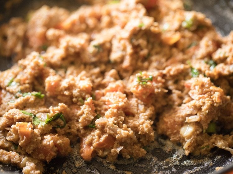 Brinjal curry mixture cooking in skillet.