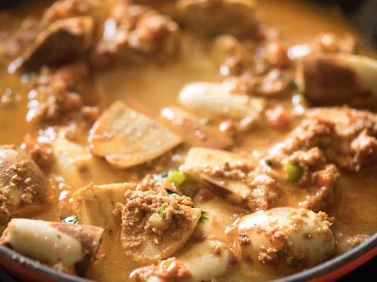 water added to eggplant curry mixture in skillet.