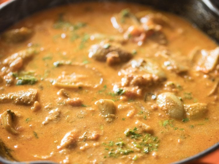 Closeup shot of baingan masala cooking in skillet.