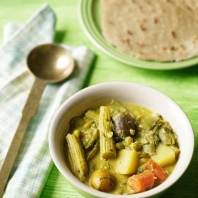 bhogichi bhaji served in a green colored ceramic bowl with a spoon kept on the left side and a plate of bhakri kept in the top right side and text layovers.