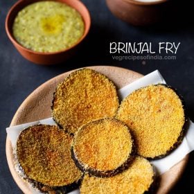 brinjal fry served on a butter paper placed on a ceramic plate with a bowl of khichdi and curd kept in the background and text layover.