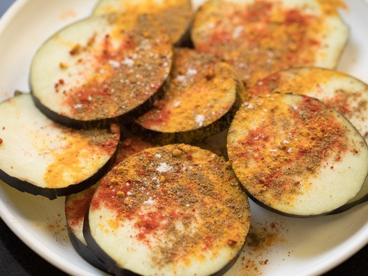 spice powders sprinkled on brinjal slices. 