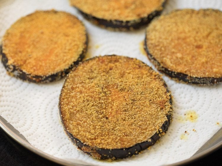 brinjal fry placed on kitchen paper towel. 