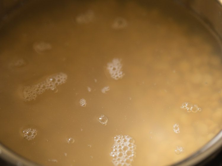 pan with chana dal and water kept on stovetop. 