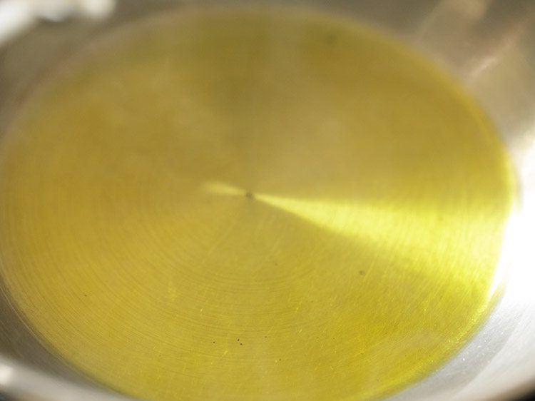 heating mustard oil in a pan. 