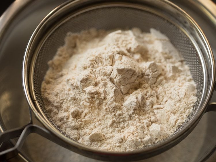 whole wheat flour in a sieve