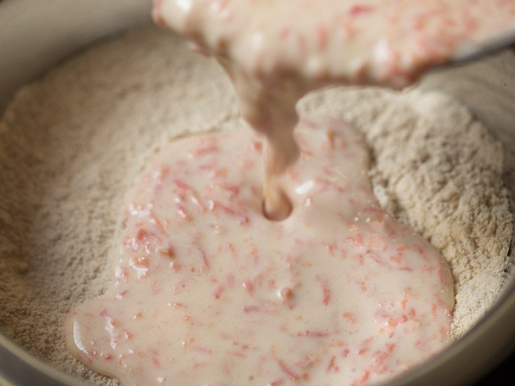 liquid mixture being poured to sifted dry ingredients 