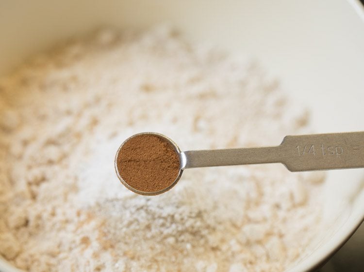 ground cinnamon powder being added.