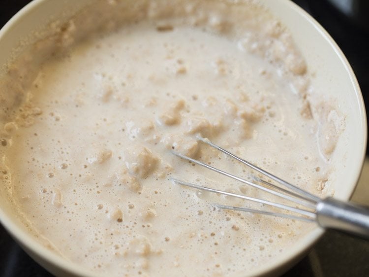 mixing eggless pancake batter with wired whisk.