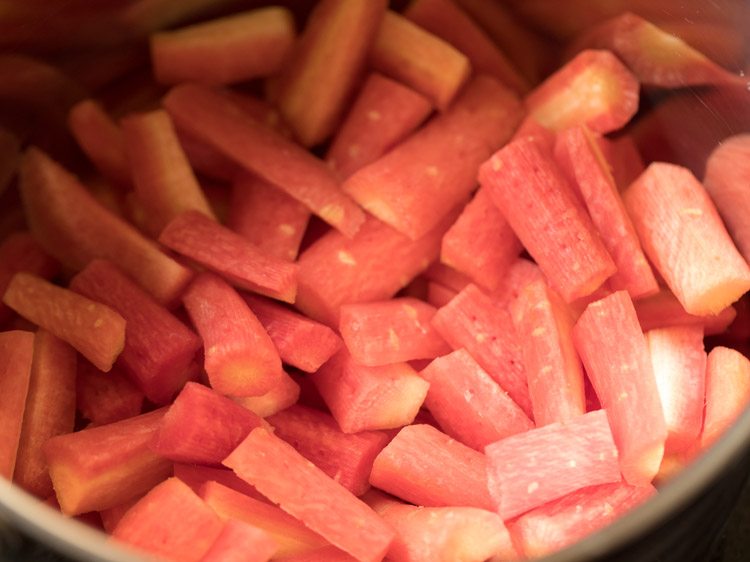 chopped carrots placed in a heavy pan. 