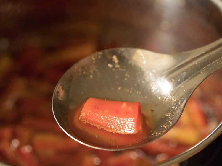 cooked carrot piece in a spoon. 