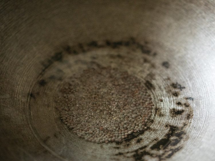 crackling mustard seeds in hot oil in heavy pan. 