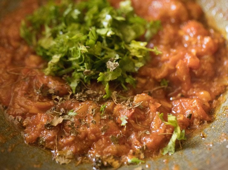 chopped coriander leaves and crushed dried fenugreek leaves added to onion-tomato masala. 