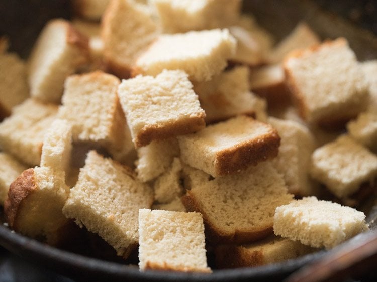 bread cubes added in onion-tomato masala. 