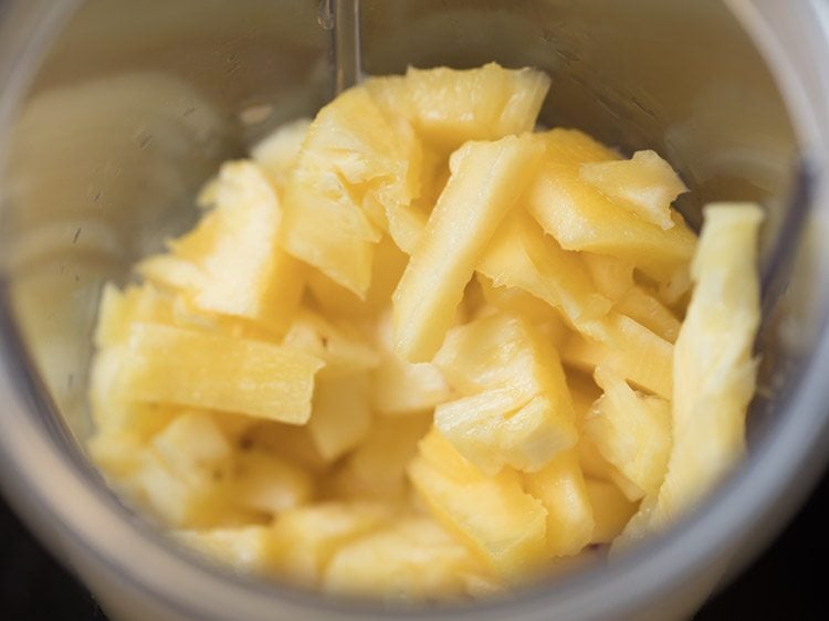 chopped pineapple in blender jar. 