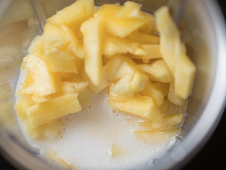 coconut milk added to jar with pineapple. 