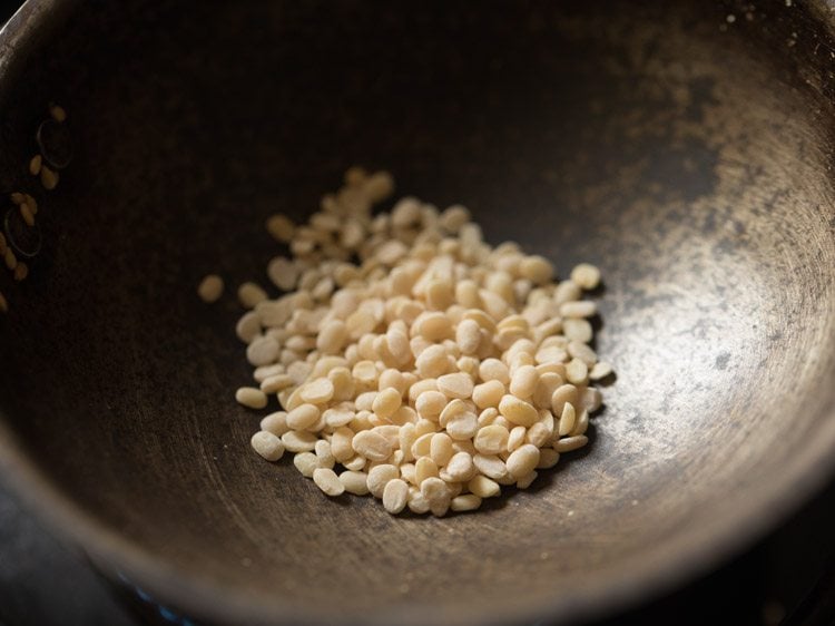 urad dal added to the pan after removing roasted sesame seeds.