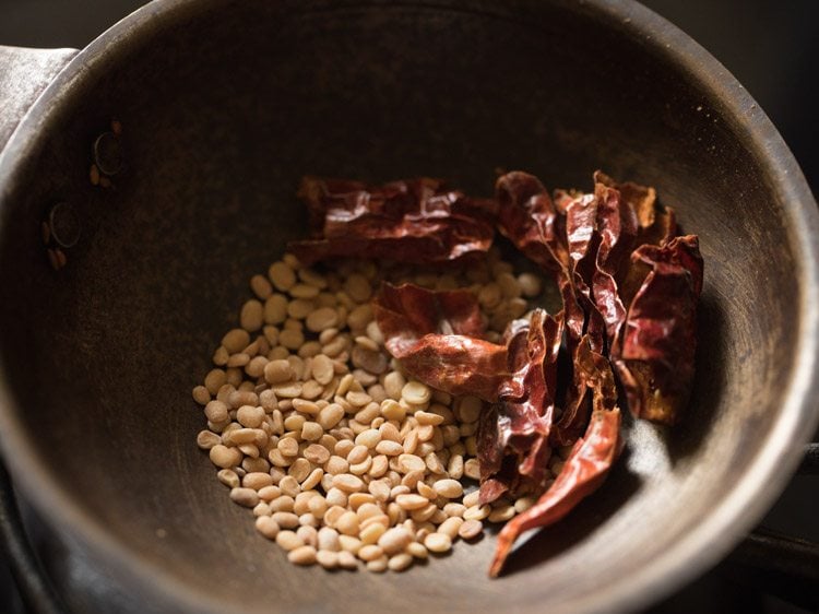 roasting dried red chilies with urad dal.