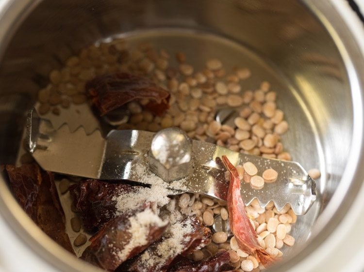 roasted dried red chilies, urad dal and asafoetida added to a grinder jar. 