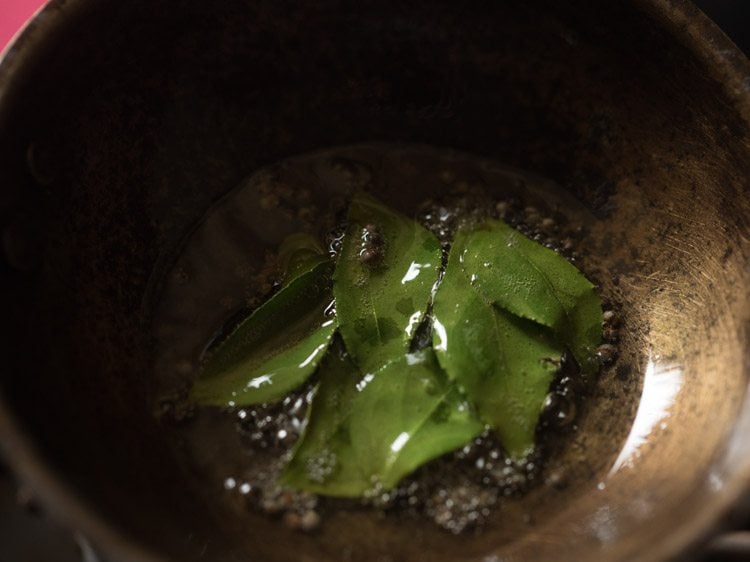stirring the curry leaves in the oil. 