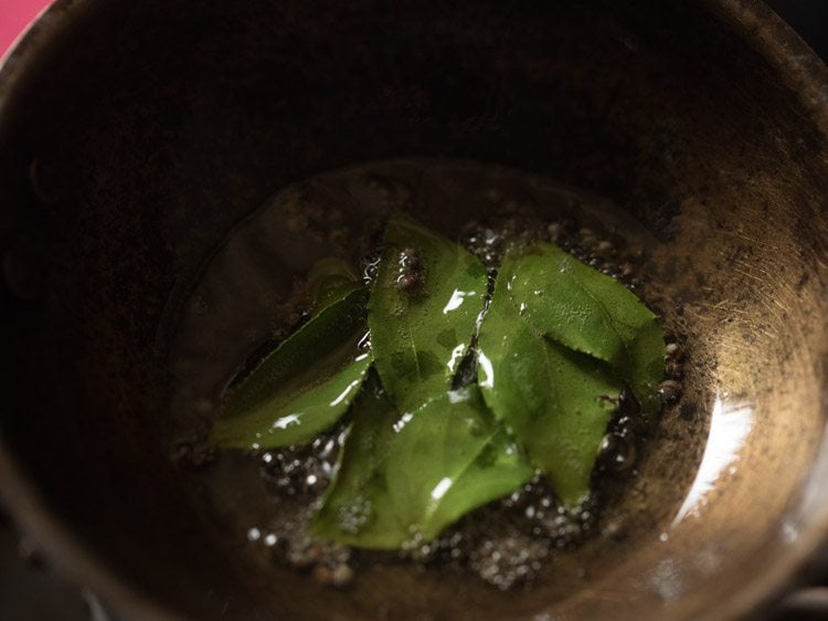 stirring the curry leaves in the oil.