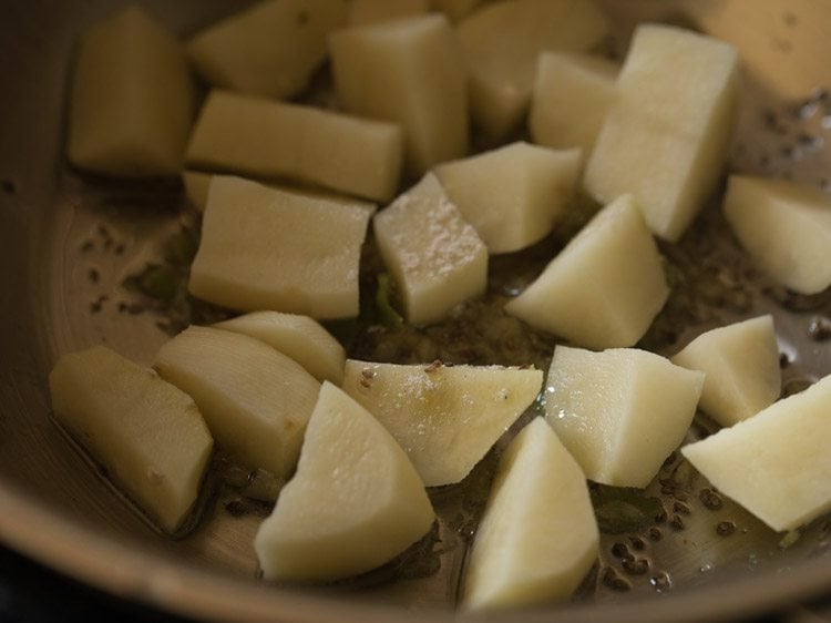 asafoetida added to potatoes for making papdi bhaji. 