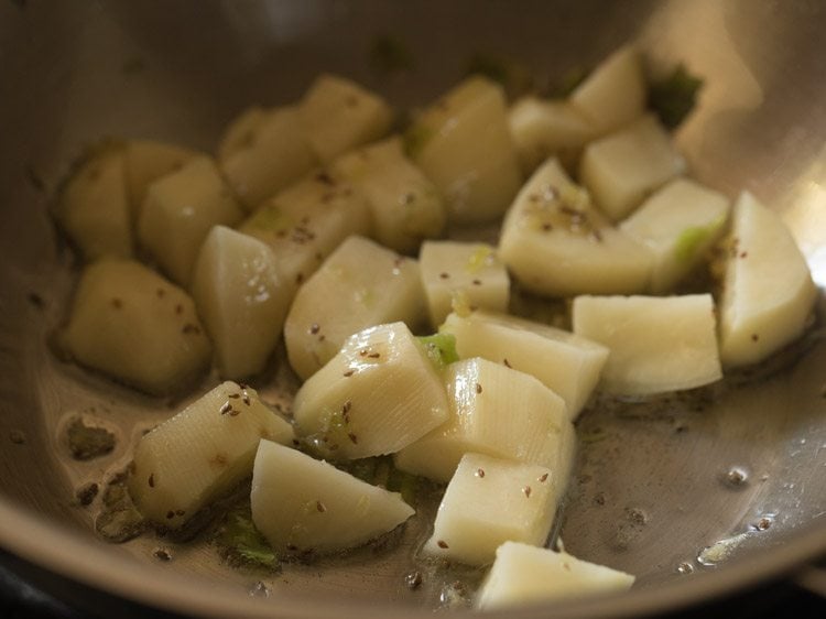sautéing potatoes for making papdi bhaji. 