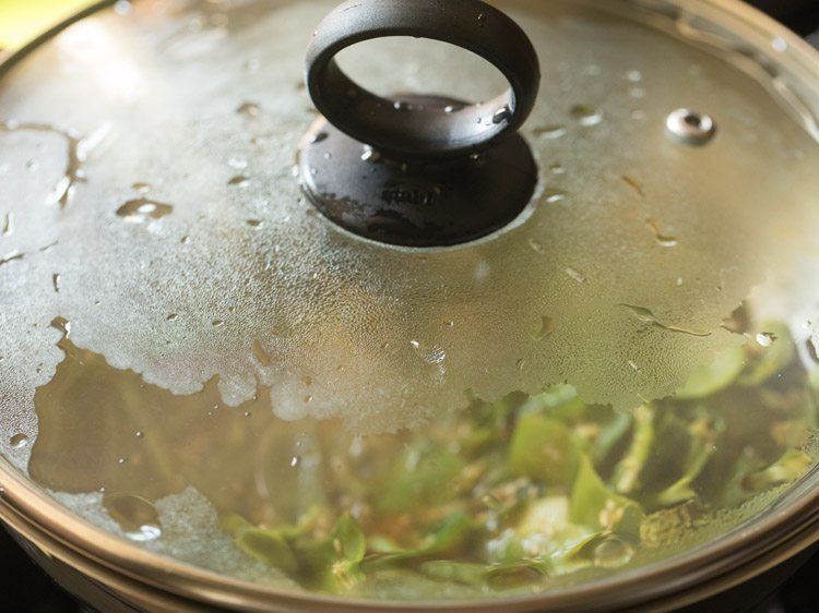 simmering aloo sem ki sabji in covered pan. 