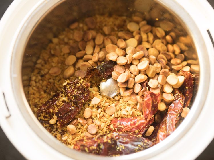 roasted coconut-spice mixture and roasted chana dal added to a grinder jar. 